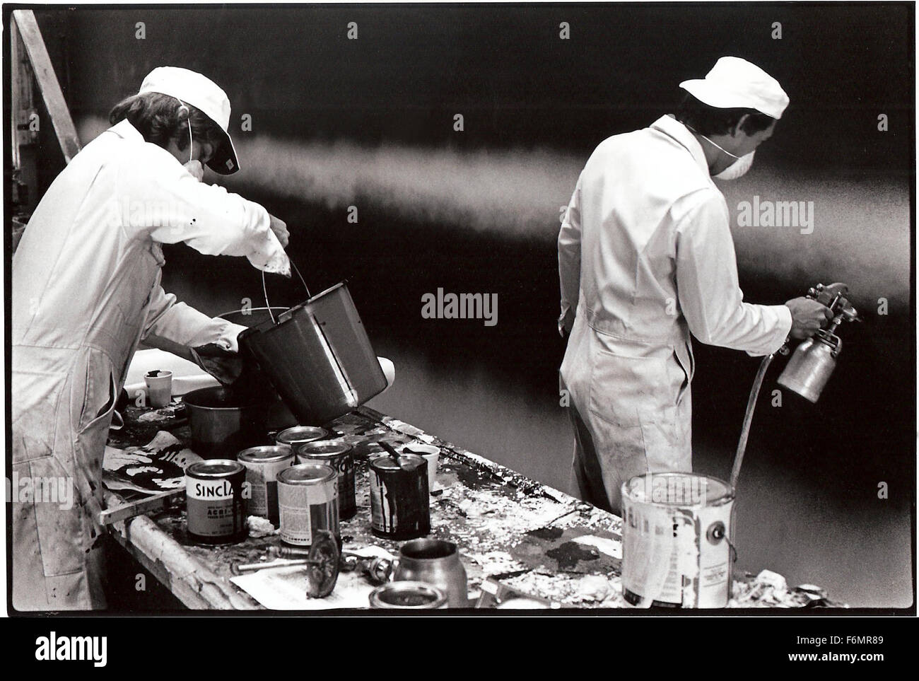 Artist Ed Ruscha (right) painting  Back of Hollywood as a billboard for the Eyes and Ears billboard project in 1977 in Los Angeles, CA Stock Photo