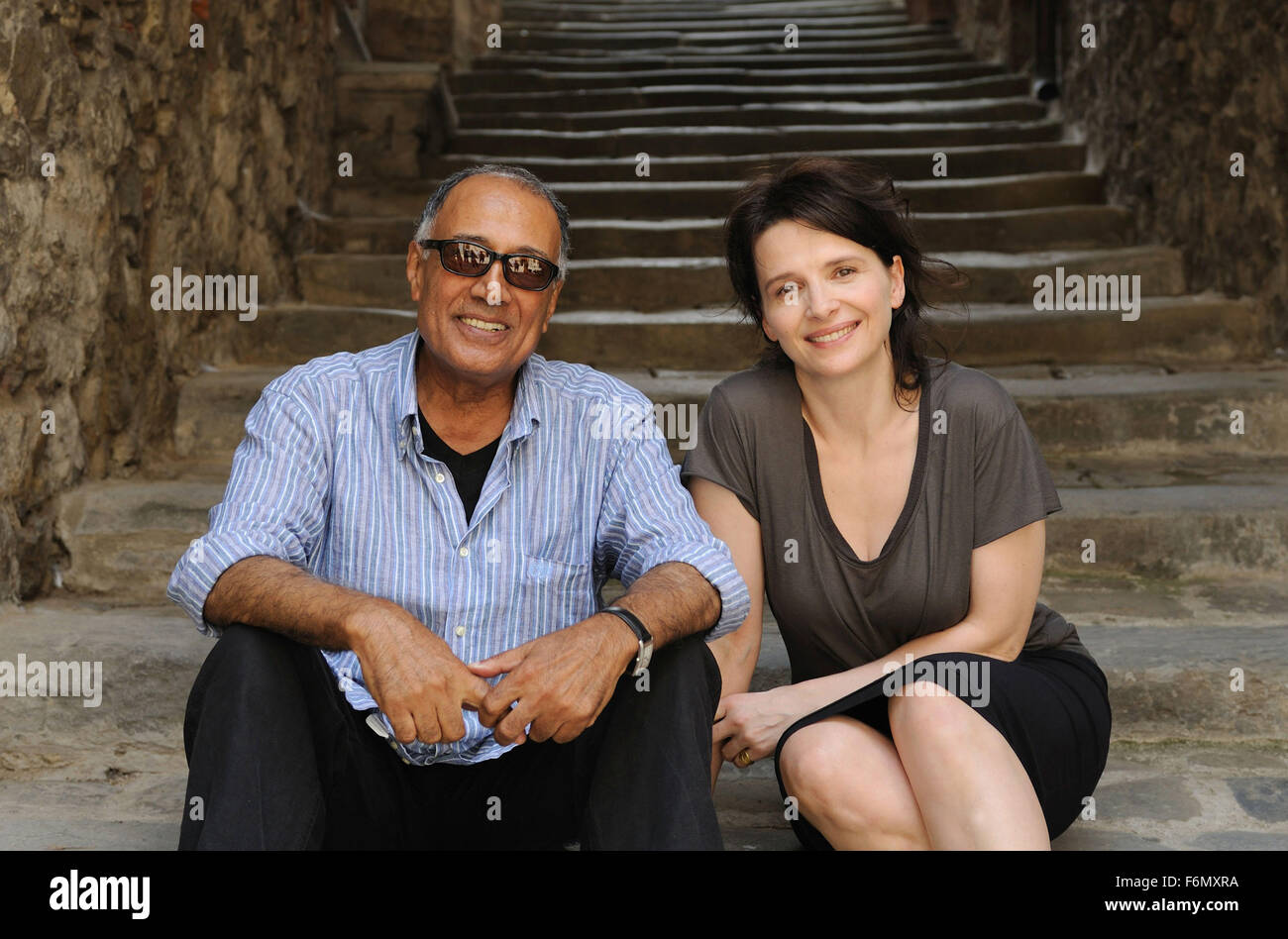 RELEASE DATE: October 1, 2010. MOVIE TITLE: Certified Copy. STUDIO: MK2 Productions. PLOT: In Tuscany to promote his latest book, a middle-aged English writer meets a French woman who leads him to the village of Lucignano. PICTURED: JULIETTE BINOCHE and ABBAS KIAROSTAMI the director. Stock Photo
