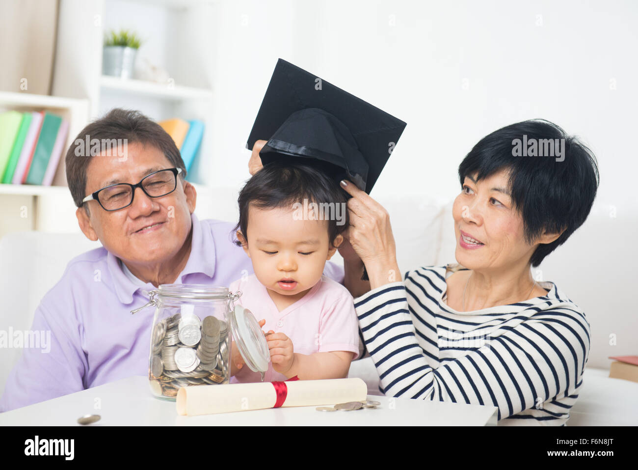 chinese senior saving money for grand children education Stock Photo