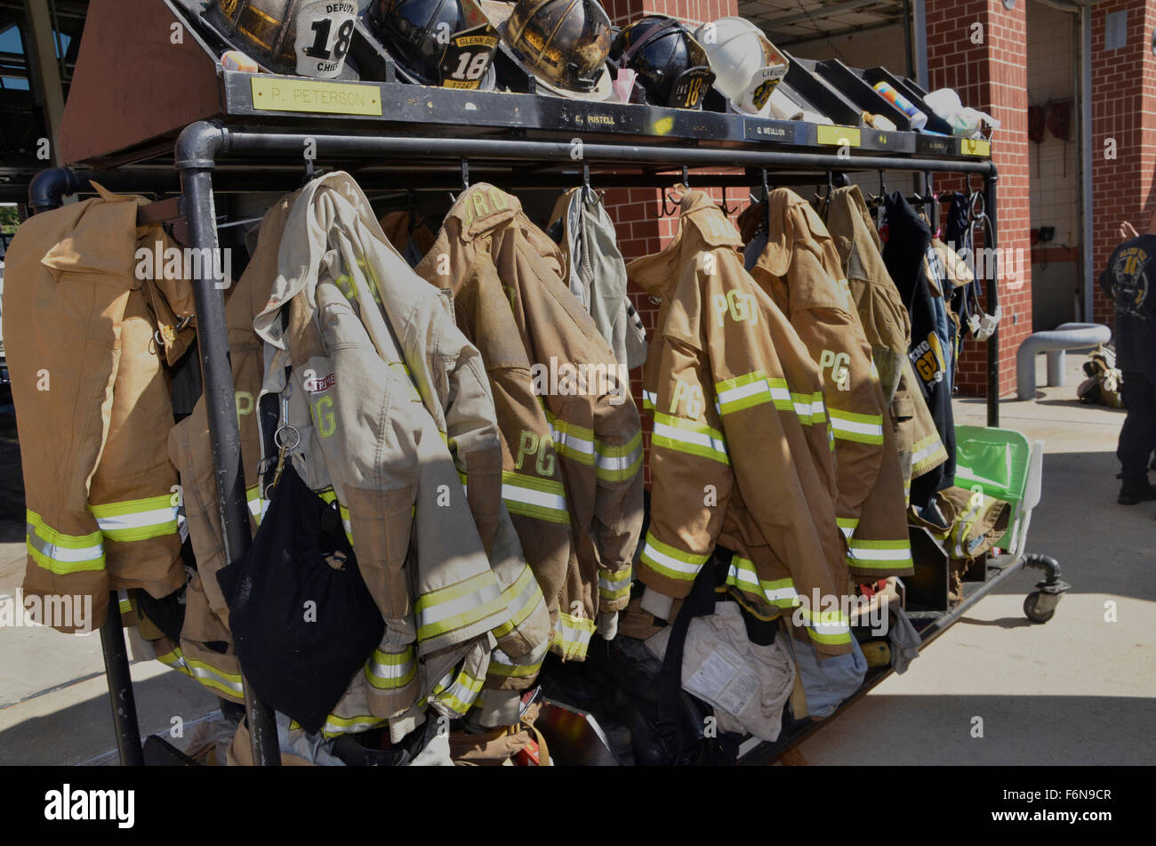 Firefighters running gear hanging on a rack Stock Photo
