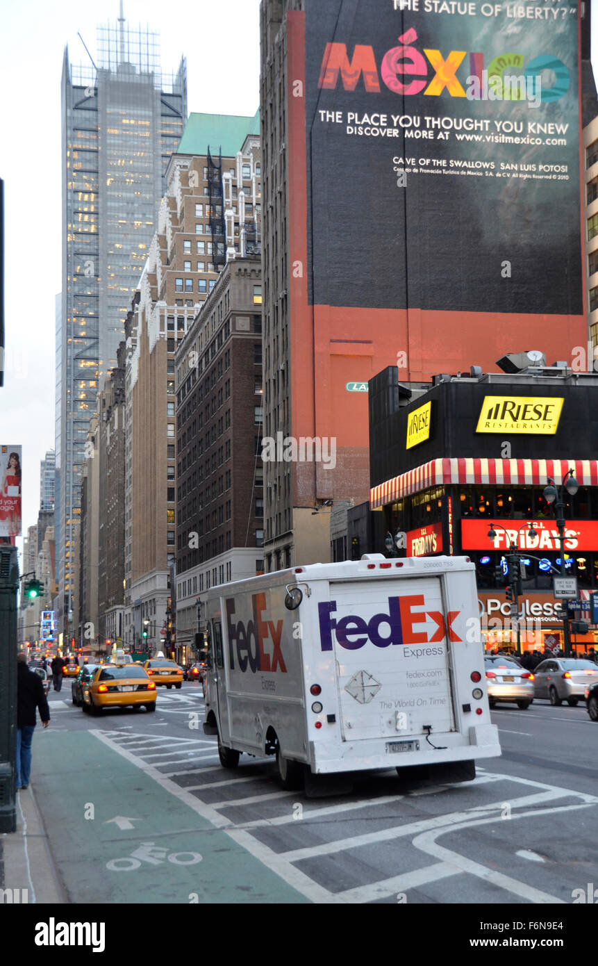 a fedex truck drives past a large sign advertising mexico on a street in new york - Fedex Garden City a fedex truck drives past a large sign advertising mexico on a street in new york - Fedex Garden City