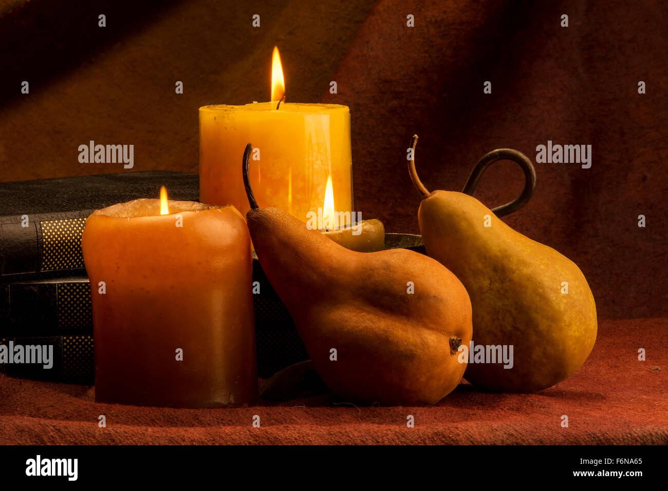 Pears candles and books Stock Photo