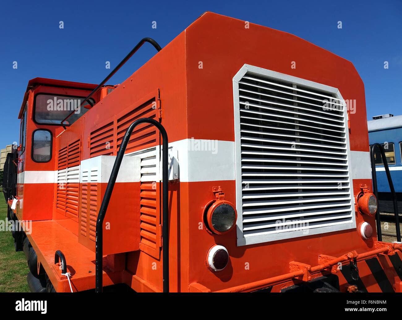 A vintage diesel engine in red and white against a blue sky Stock Photo