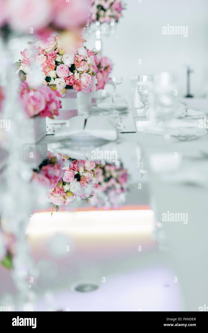 Beautiful wedding table arrangement with decorative elements and roses ...