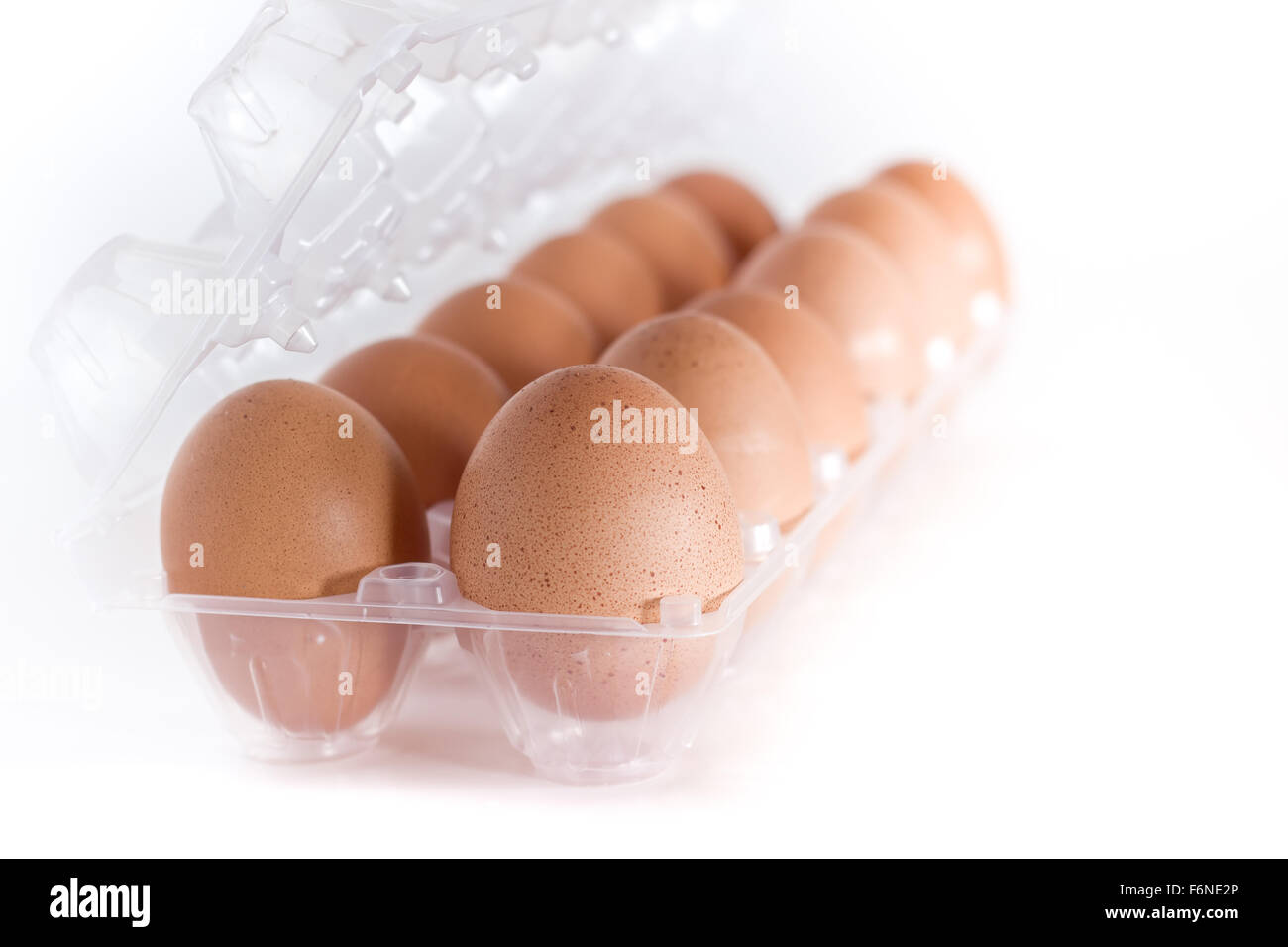 Container for eggs in clear plastic, isolated on a white background