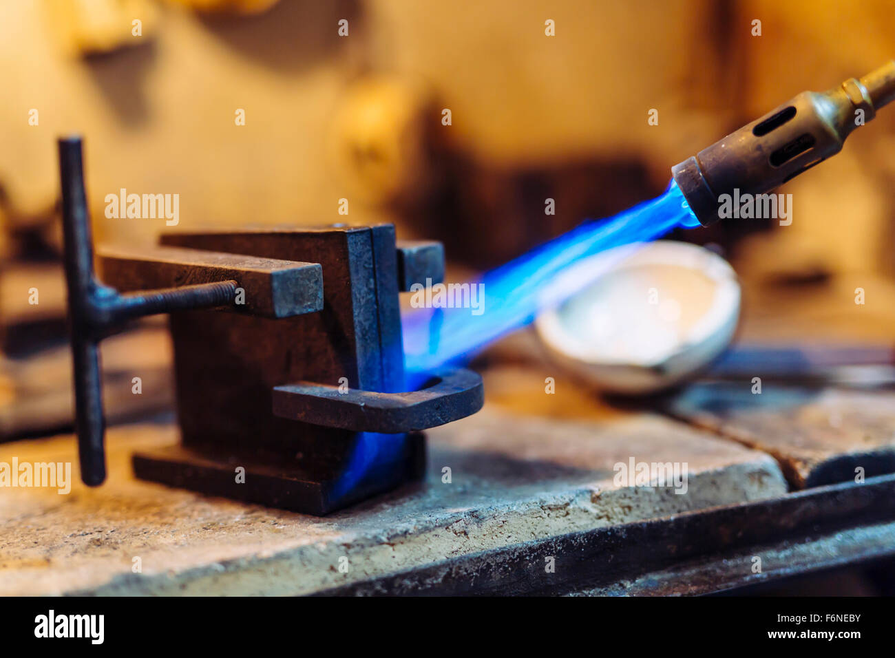 Jeweler using torch to heat welding tools to proper temperature Stock Photo Alamy
