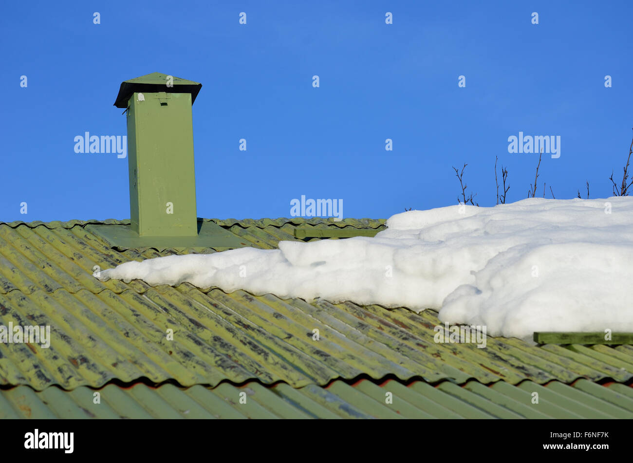 green house roof with chimney and snow in sunshine Stock Photo - Alamy