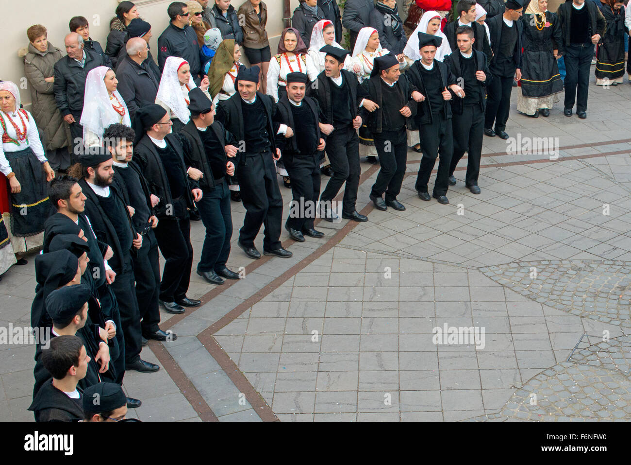 sardinian people in traditional clothes during a dance in Carnival