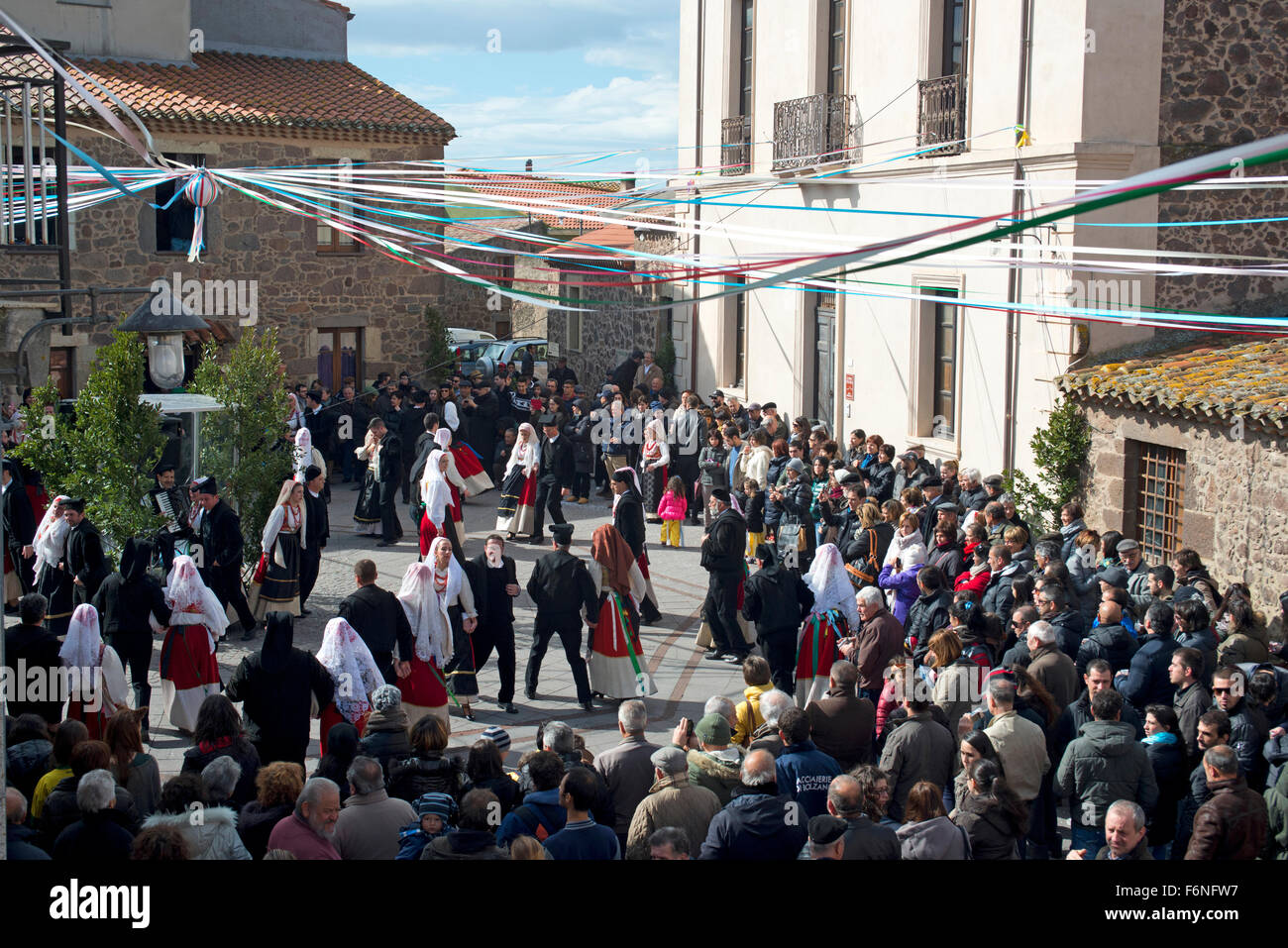sardinian people in traditional clothes during a dance in Carnival