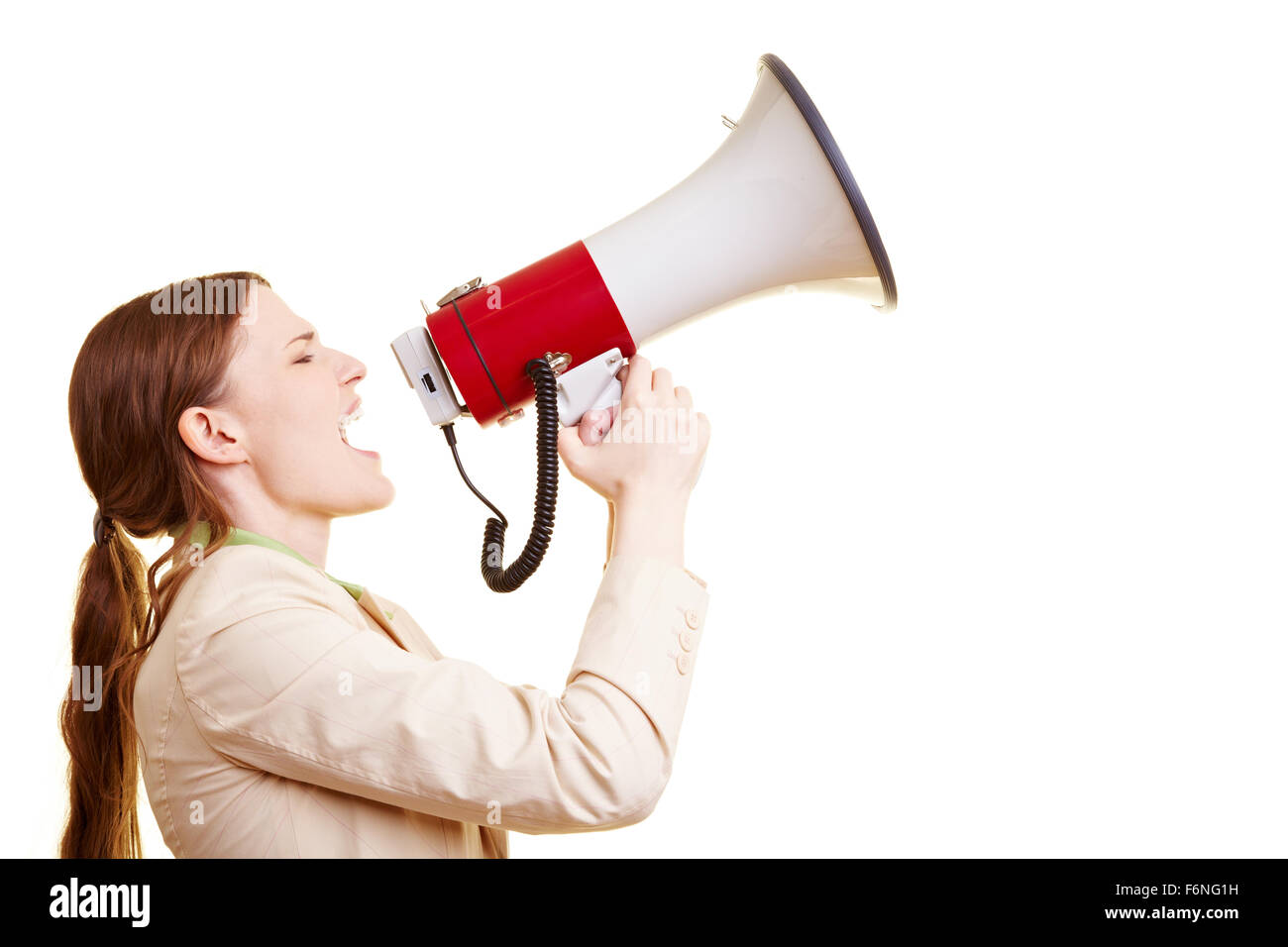 Businesswoman screaming loudly in a big megaphone Stock Photo