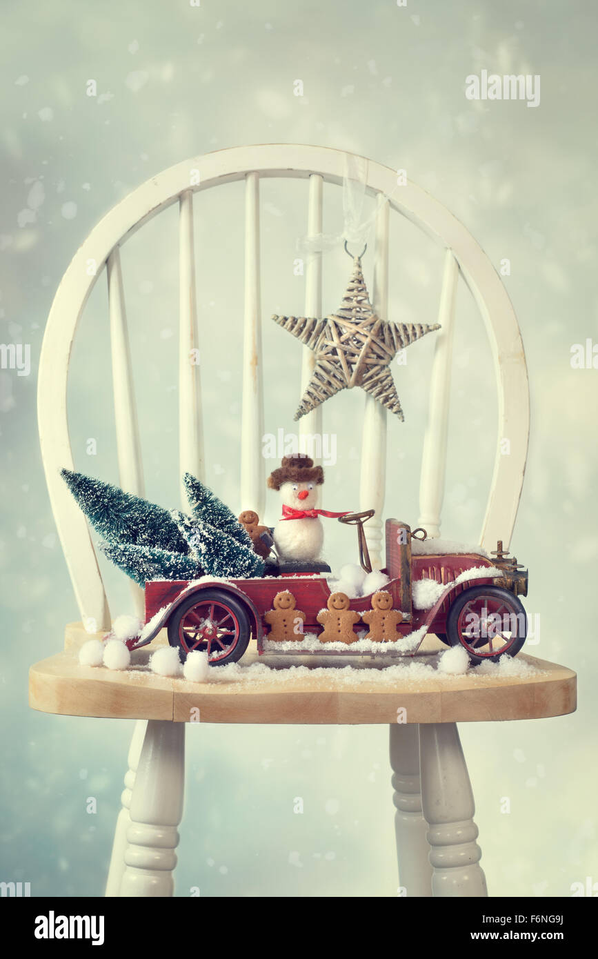 Vintage red truck snow scene with gingerbread men and snowman Stock Photo
