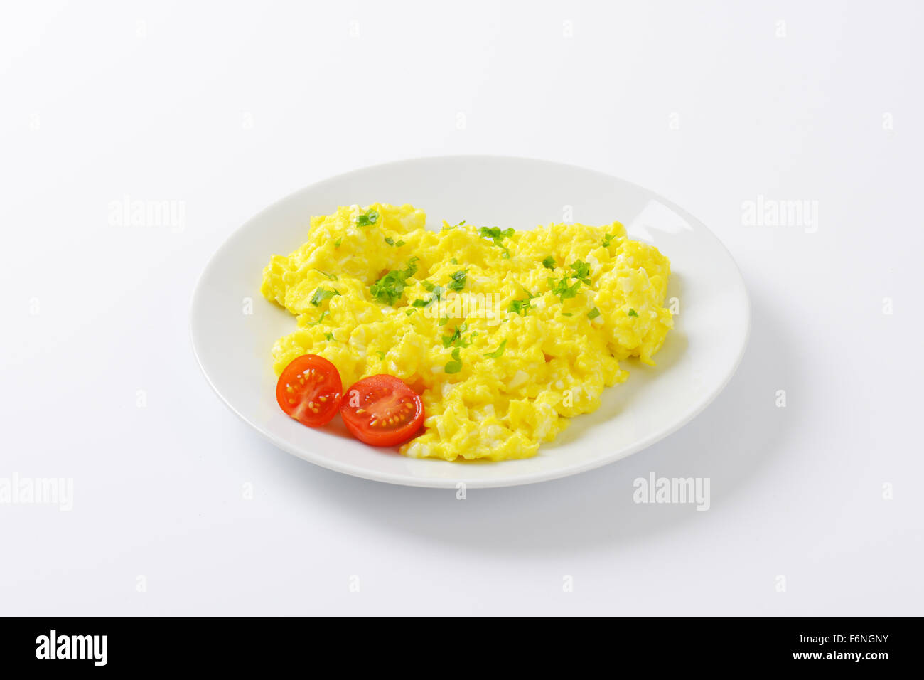 plate of scrambled eggs on white background Stock Photo - Alamy