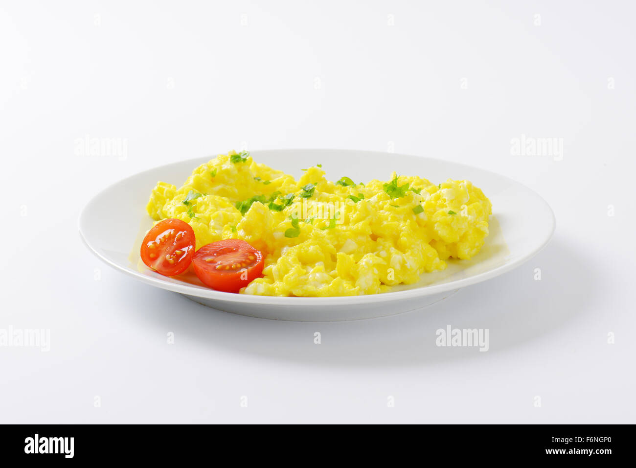 plate of scrambled eggs on white background Stock Photo - Alamy
