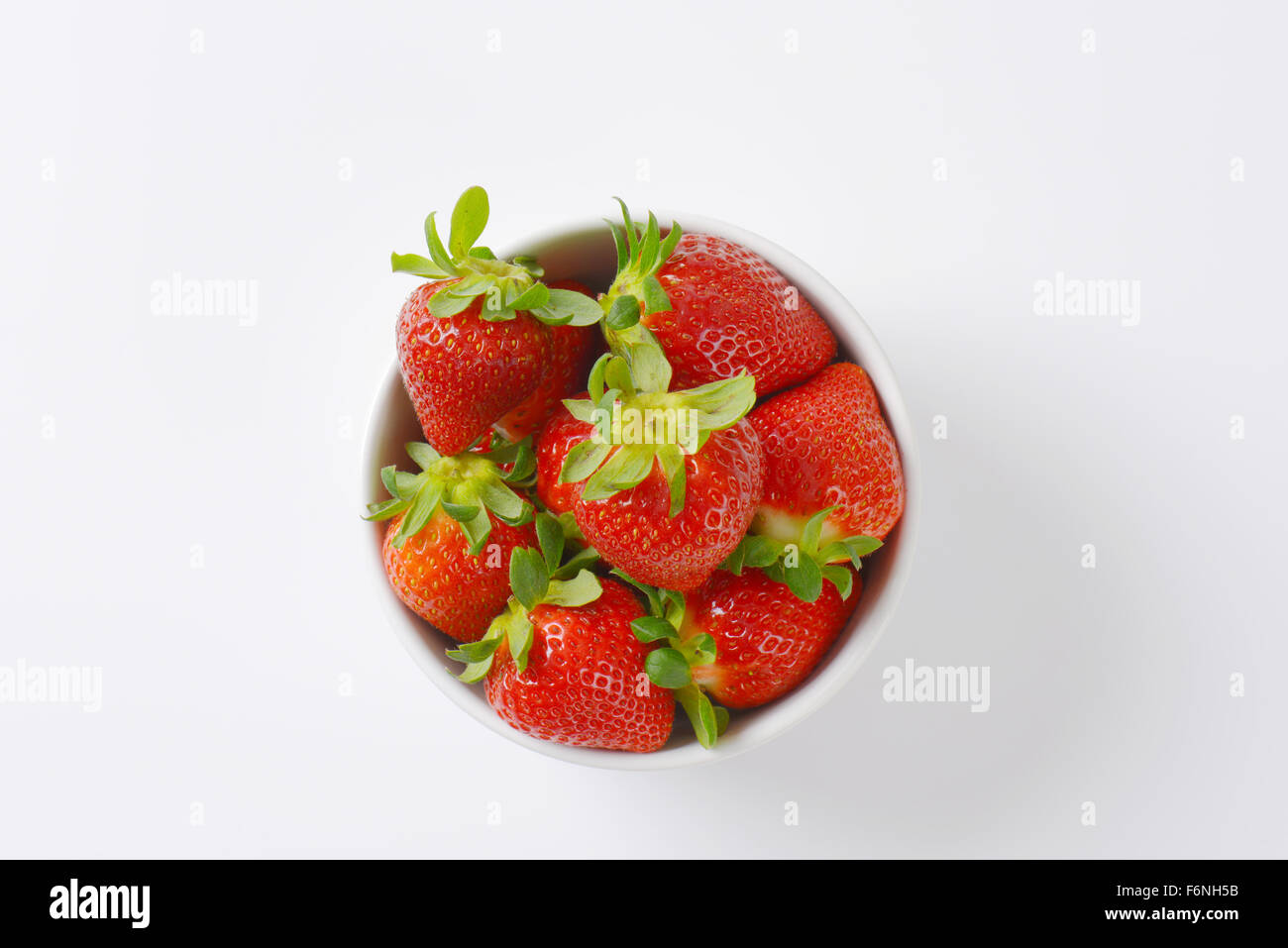 bowl of fresh strawberries on white background Stock Photo - Alamy