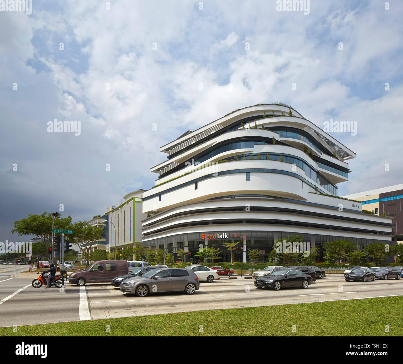 General exterior elevation across busy intersection. BreadTalk IHQ, Singapore, Singapore. Architect: Kay Ngeee Tan Architects, 2 Stock Photo