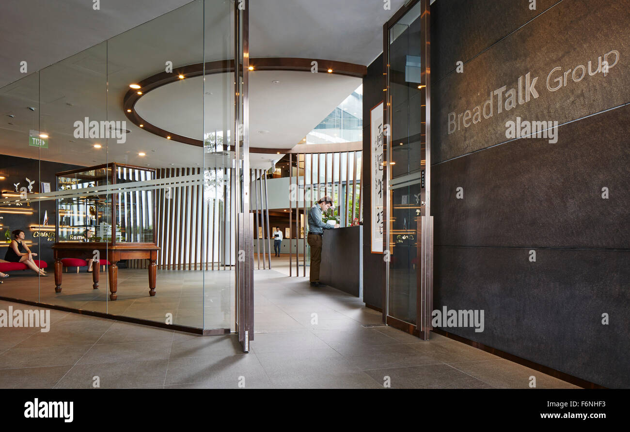 Glazed entrance and reception. BreadTalk IHQ, Singapore, Singapore. Architect: Kay Ngeee Tan Architects, 2014. Stock Photo