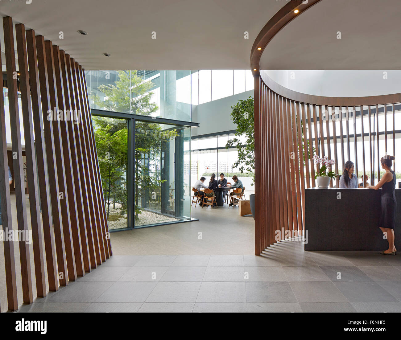 Reception desk with view towards entrance hall. BreadTalk IHQ, Singapore, Singapore. Architect: Kay Ngeee Tan Architects, 2014. Stock Photo
