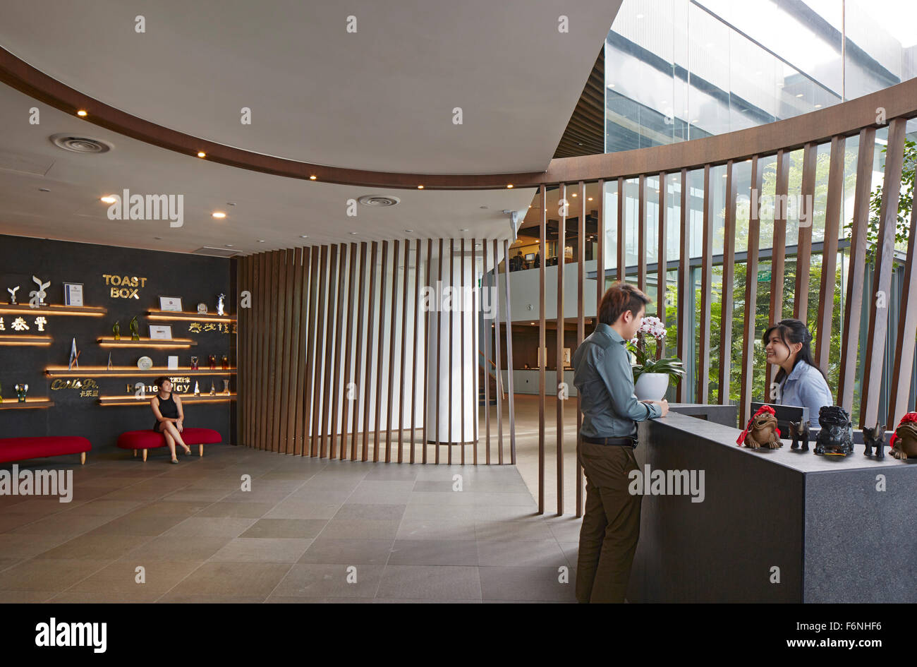 Reception desk with view towards waiting lounge. BreadTalk IHQ, Singapore, Singapore. Architect: Kay Ngeee Tan Architects, 2014. Stock Photo