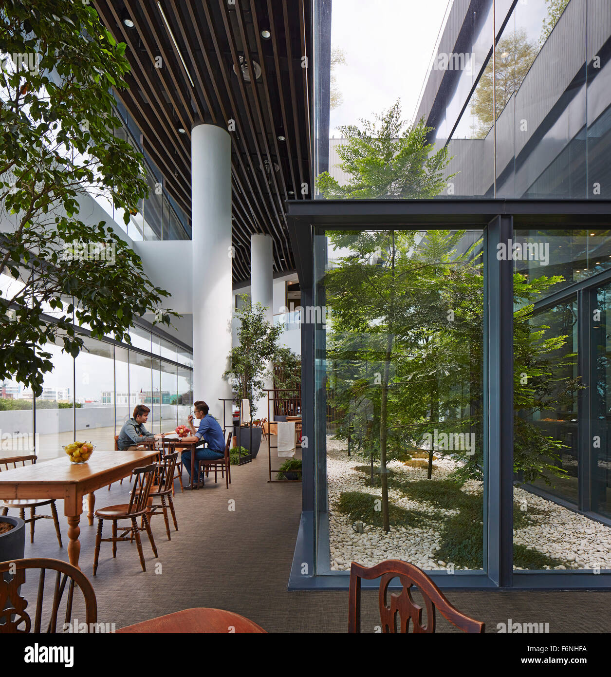 Perspective along informal meeting area. BreadTalk IHQ, Singapore, Singapore. Architect: Kay Ngeee Tan Architects, 2014. Stock Photo