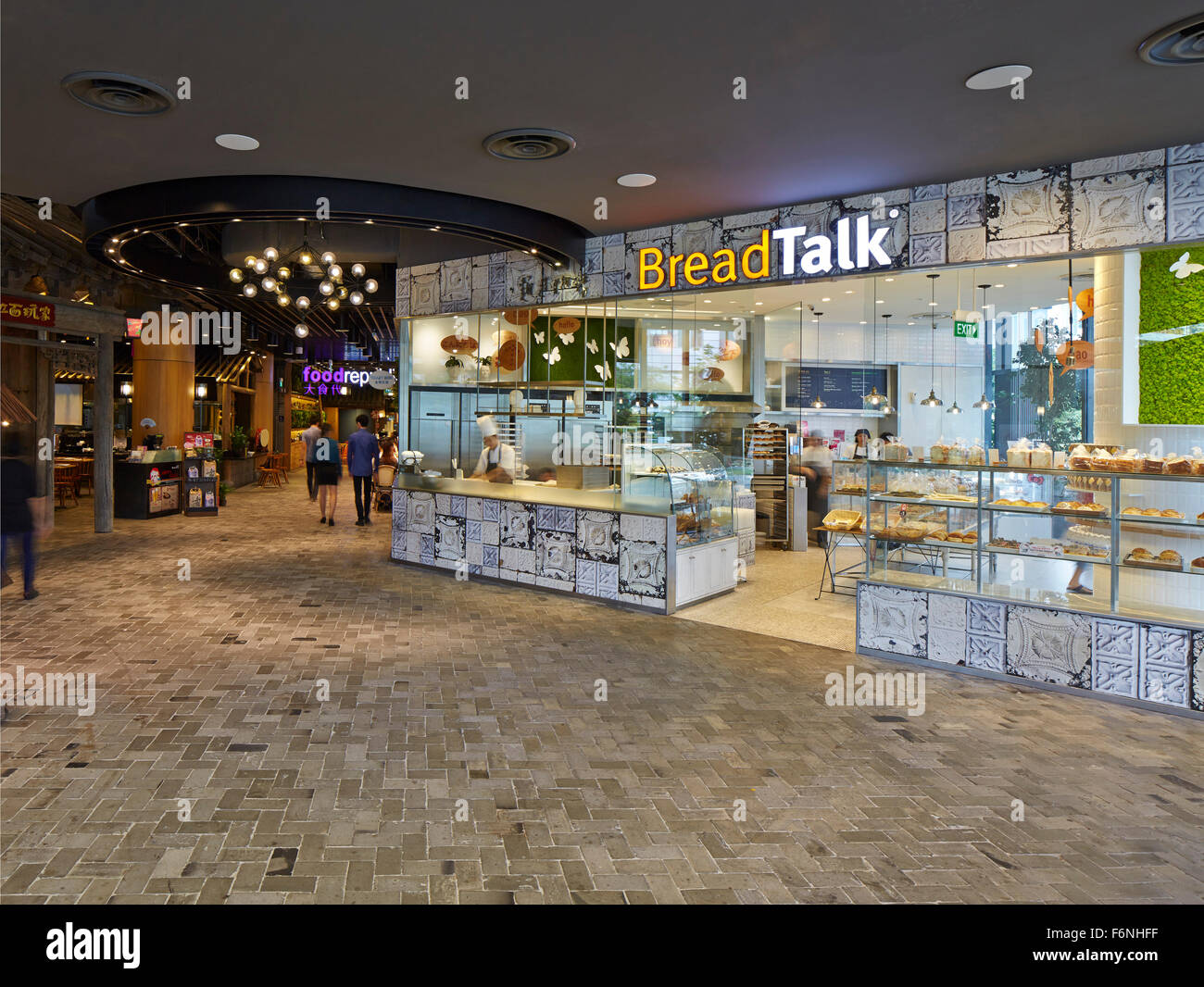 Ground floor food and retail area. BreadTalk IHQ, Singapore, Singapore. Architect: Kay Ngeee Tan Architects, 2014. Stock Photo