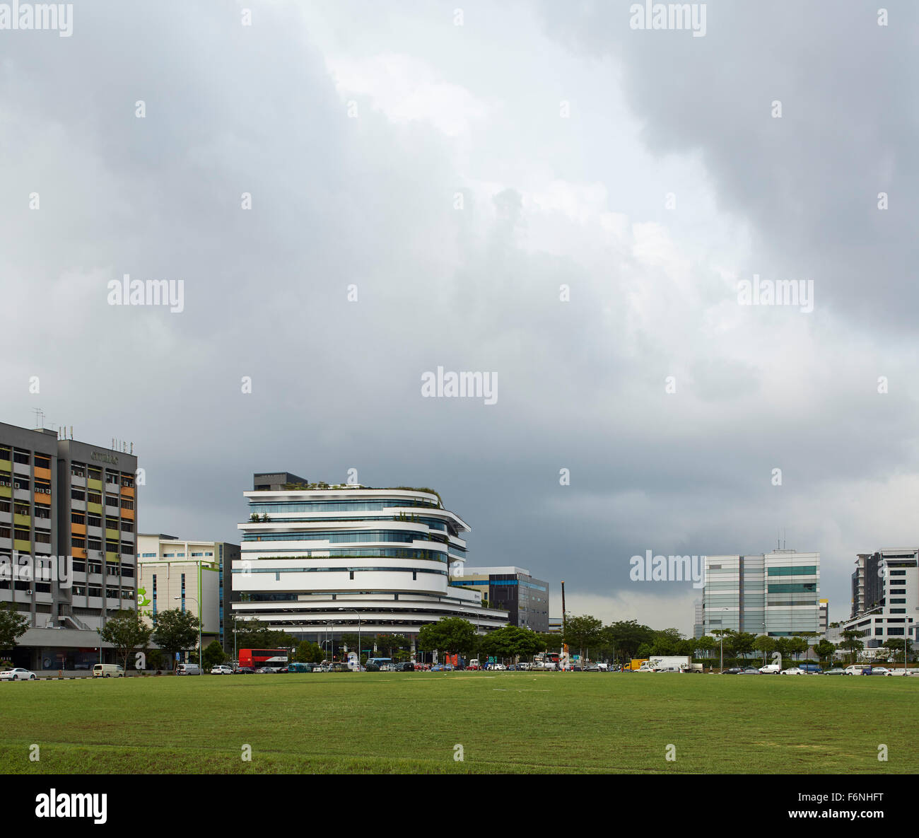 Distant elevation of building in context. BreadTalk IHQ, Singapore, Singapore. Architect: Kay Ngeee Tan Architects, 2014. Stock Photo