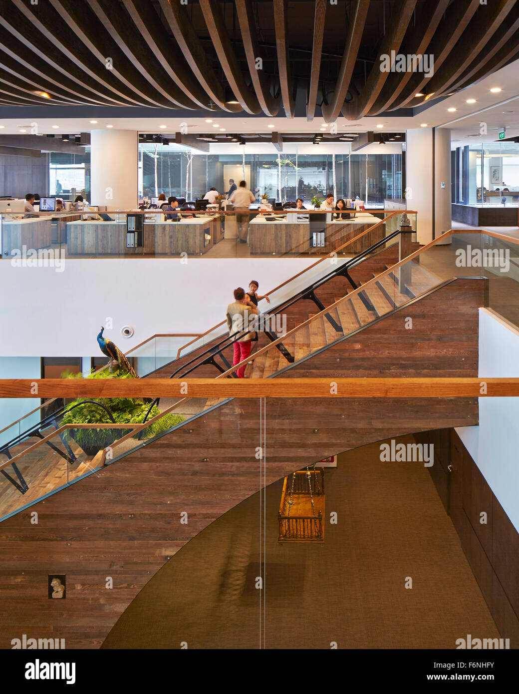 Interior from upper floor with stairway and open plan offices. BreadTalk IHQ, Singapore, Singapore. Architect: Kay Ngeee Tan Arc Stock Photo
