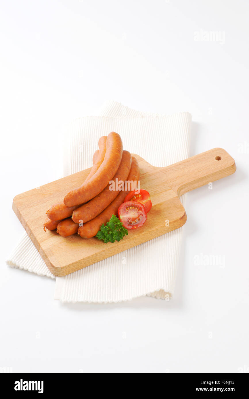 raw frankfurter sausages on wooden cutting board and white place mat Stock  Photo - Alamy