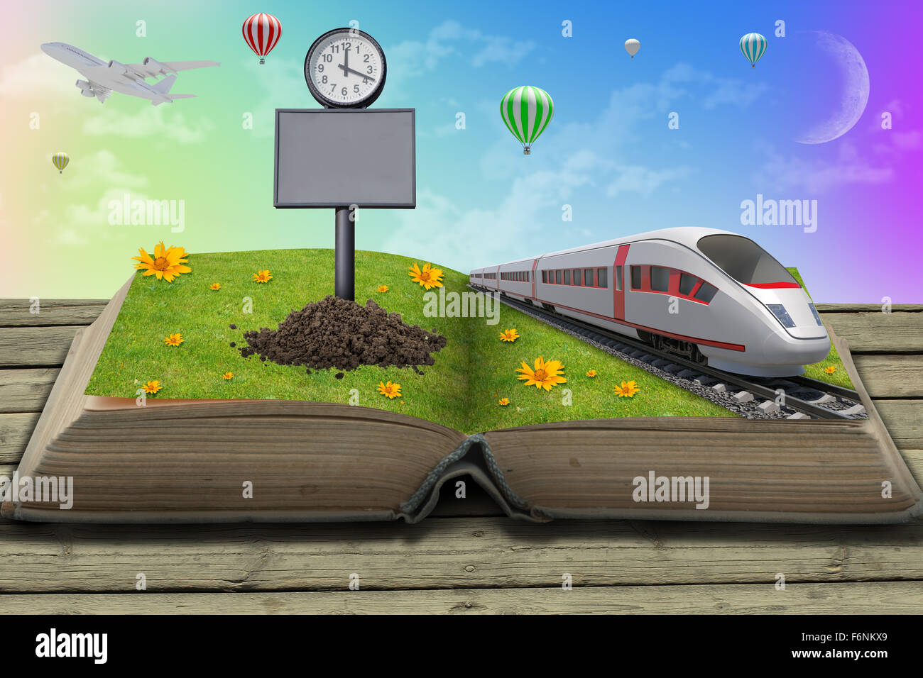 Train on open book with grass Stock Photo - Alamy