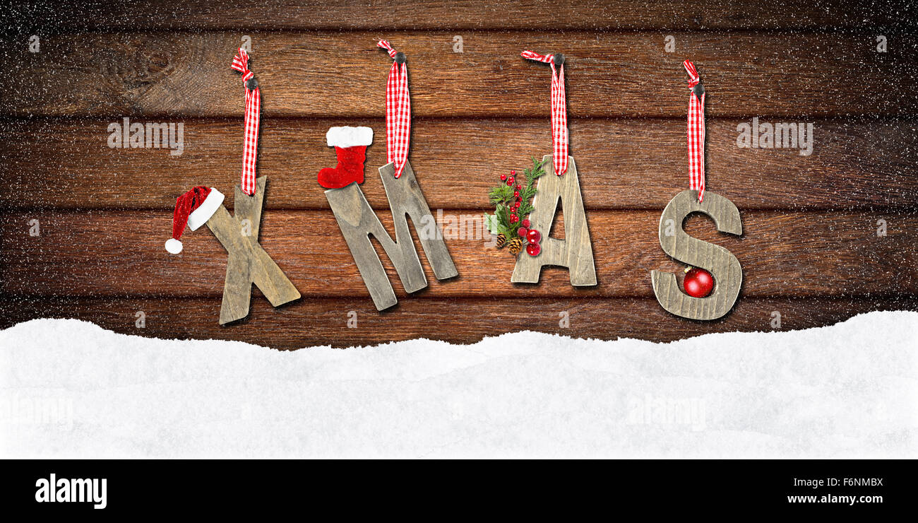 xmas lettering on wooden wall in snow Stock Photo