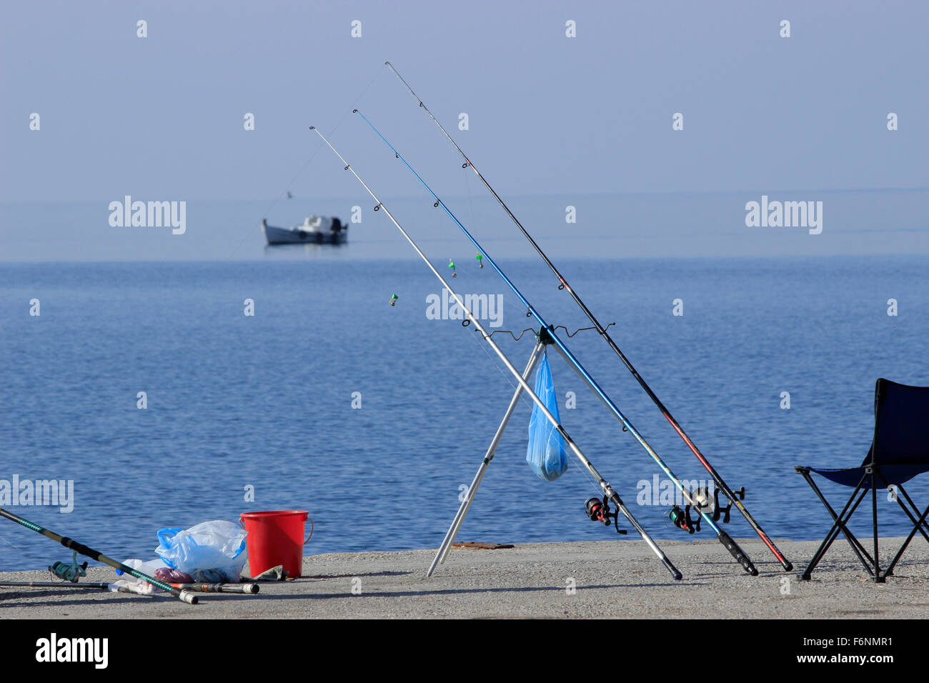 Fishing rods and holders in the port of Myrina with wooden