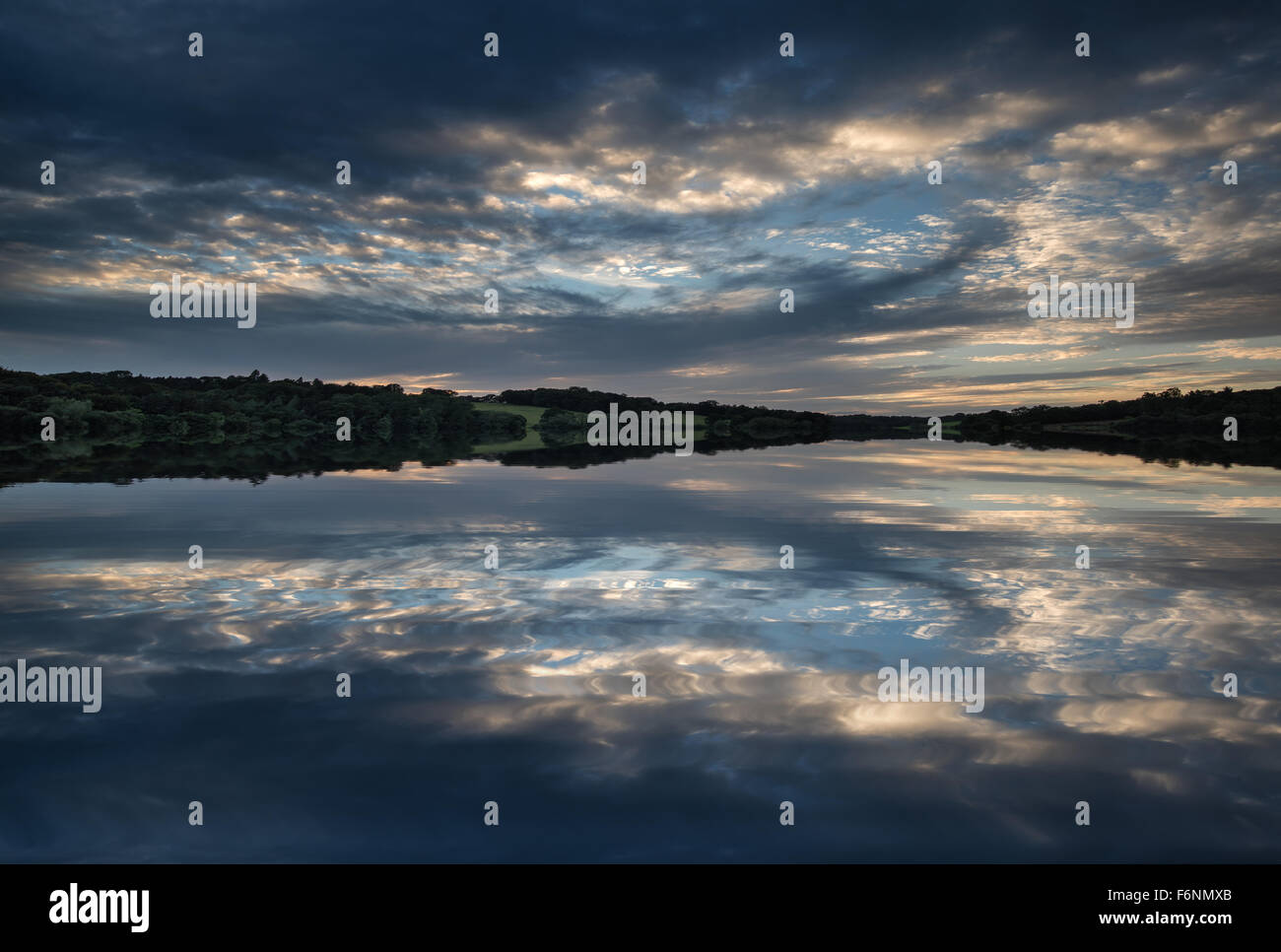 Dramatic sunset over calm lake in Summer in English countryside Stock ...