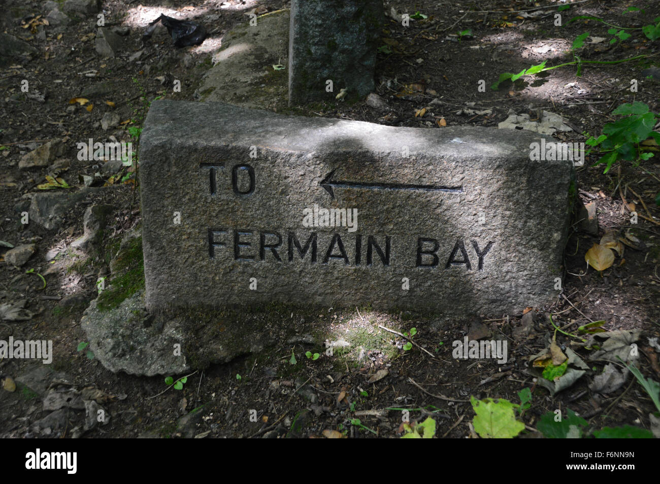 Carved Stone Waymarker to Fermain Bay on Guernsey Coastal Path Channel Islands. Stock Photo