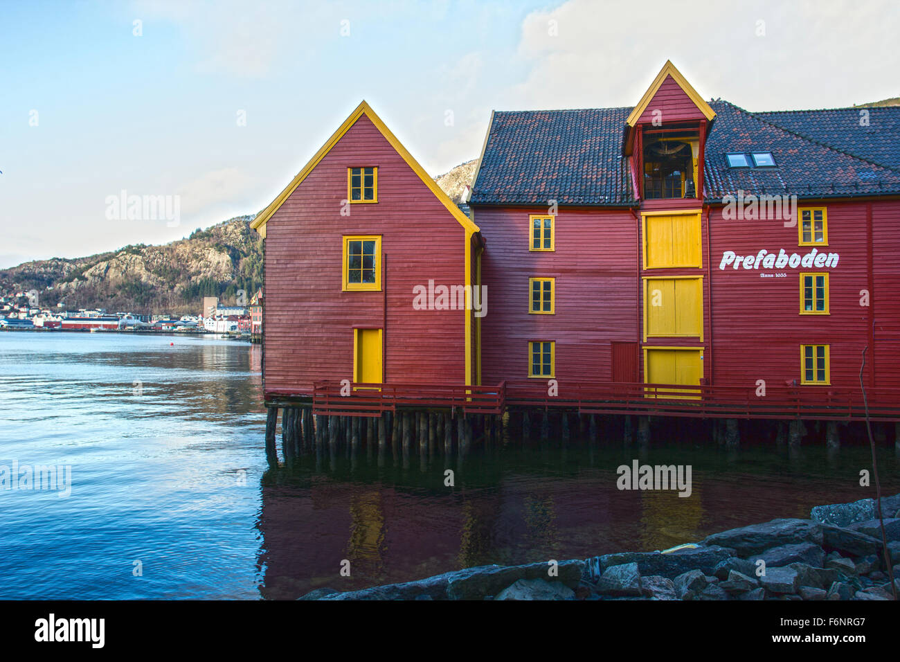 Red and yellow wooden building on stilts in bergen norway Stock Photo