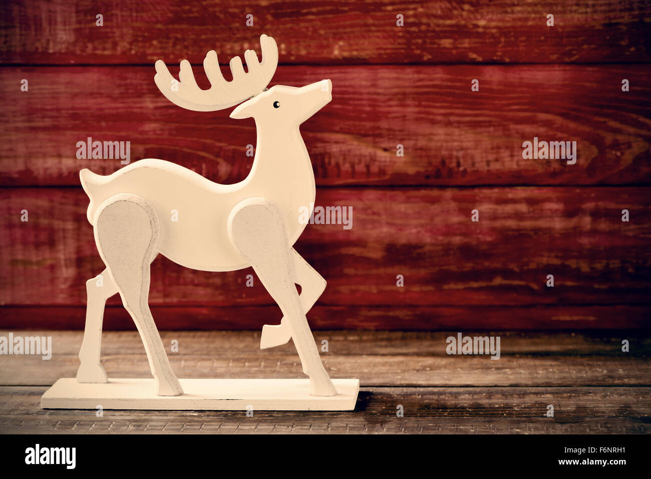 A Wooden Reindeer Shaped Ornament On A Rustic Wooden Surface Stock Photo Alamy