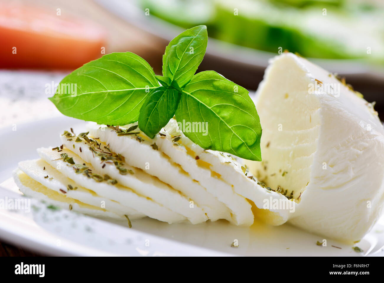 closeup of a plate with a sliced fresh cheese Stock Photo
