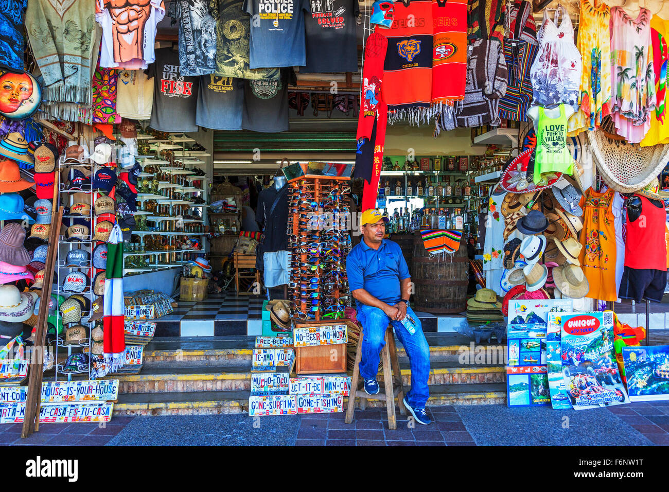 Shopkeeper sitting outside his souvenir shop, on El Macelon, Centro Zone, Puerto Vallarta, Mexico Stock Photo