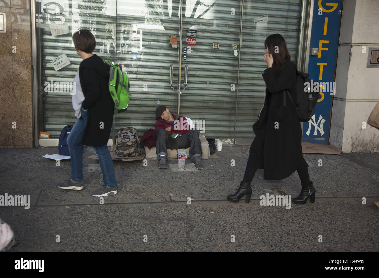 Tired out man begs for money along 34th Street in New York City. Stock Photo