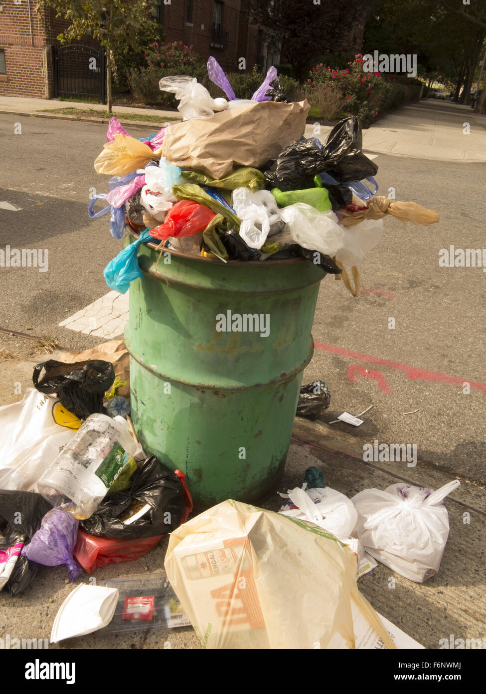 Overflowing garbage can in Brooklyn, NY. Stock Photo
