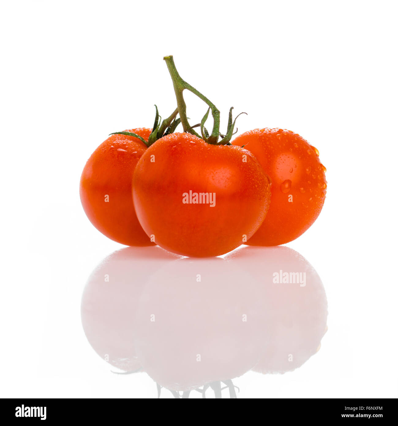 three beautiful tomatos isolated on white background Stock Photo - Alamy