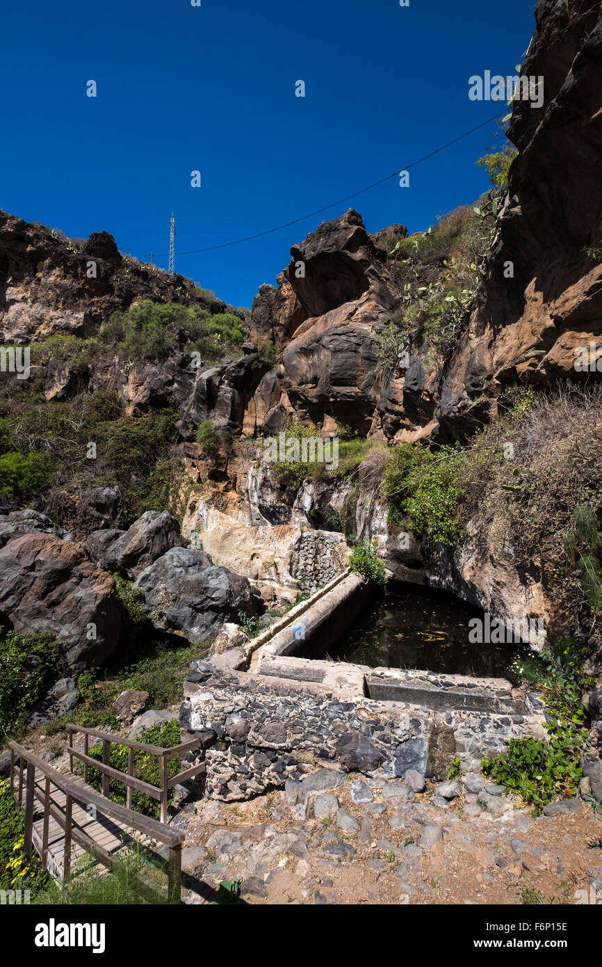 Old water reservoir and washing area at the bottom of a cliff in a barranco near San Miguel, Tenerife, Canary Islands, Spain, Stock Photo