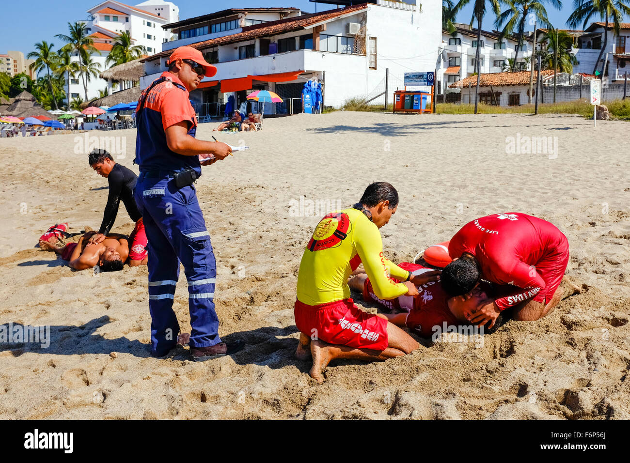 Lifeguards on the beach at Puerto Vallarta, Mexico undergoing training in rescue and lifesaving as part of their license require Stock Photo