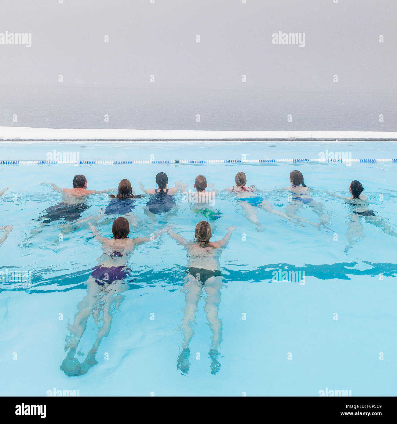 People swimming outside in the winter, geothermal heated pool, Hofsos, Iceland Stock Photo