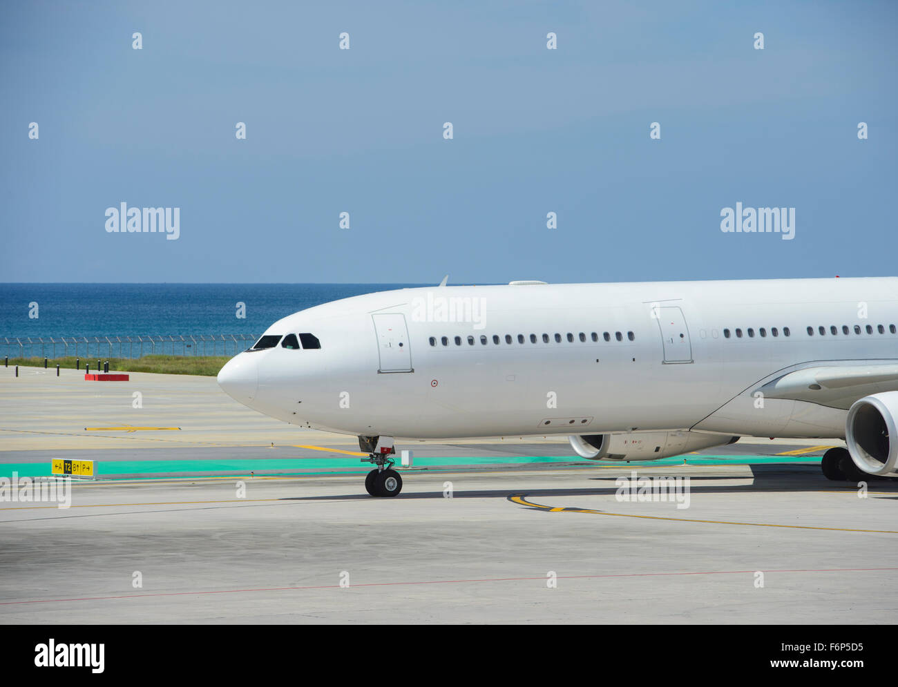 Commercial airplane taxiing on a seashore Stock Photo