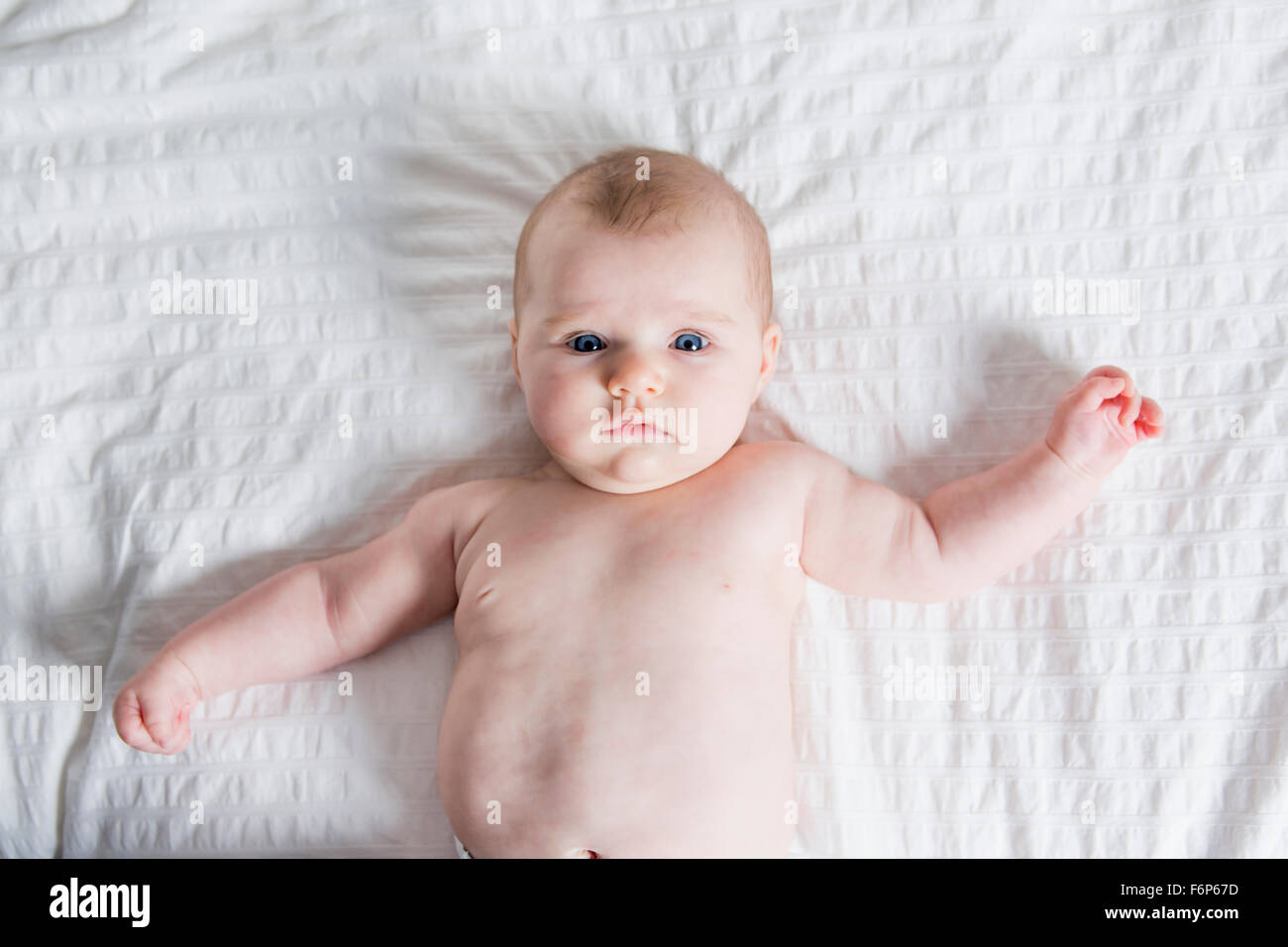 cute four month old baby in bed at home Stock Photo Alamy