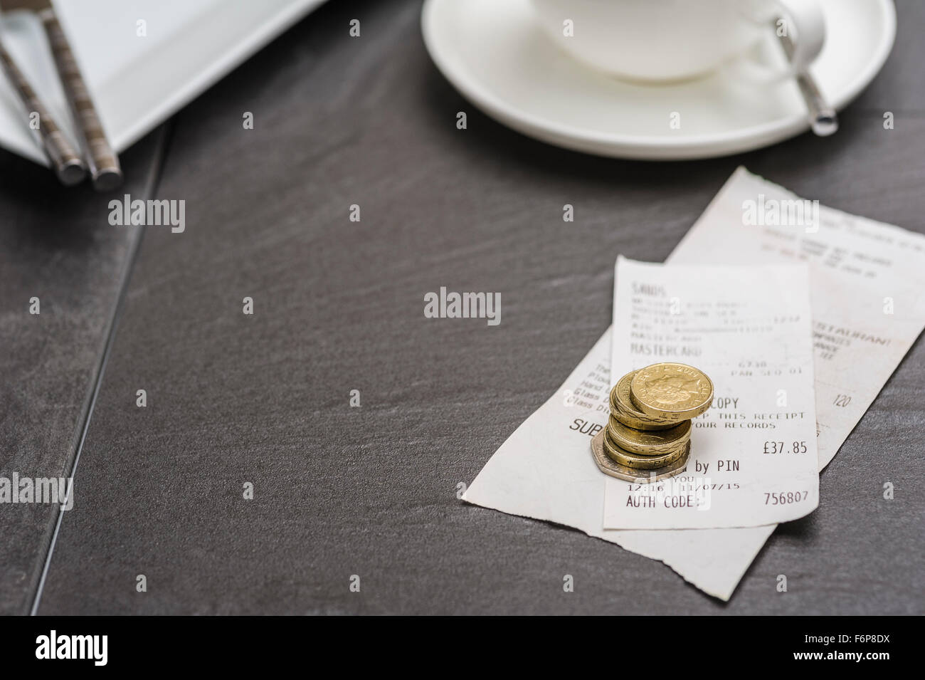 Restaurant leaving a gratuity and bill paying. Leaving a tip after a meal.or check with a tip. Stock Photo