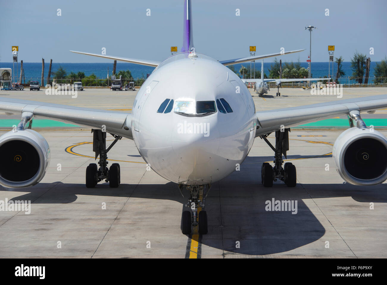 Commercial airplane taxiing to gate Stock Photo