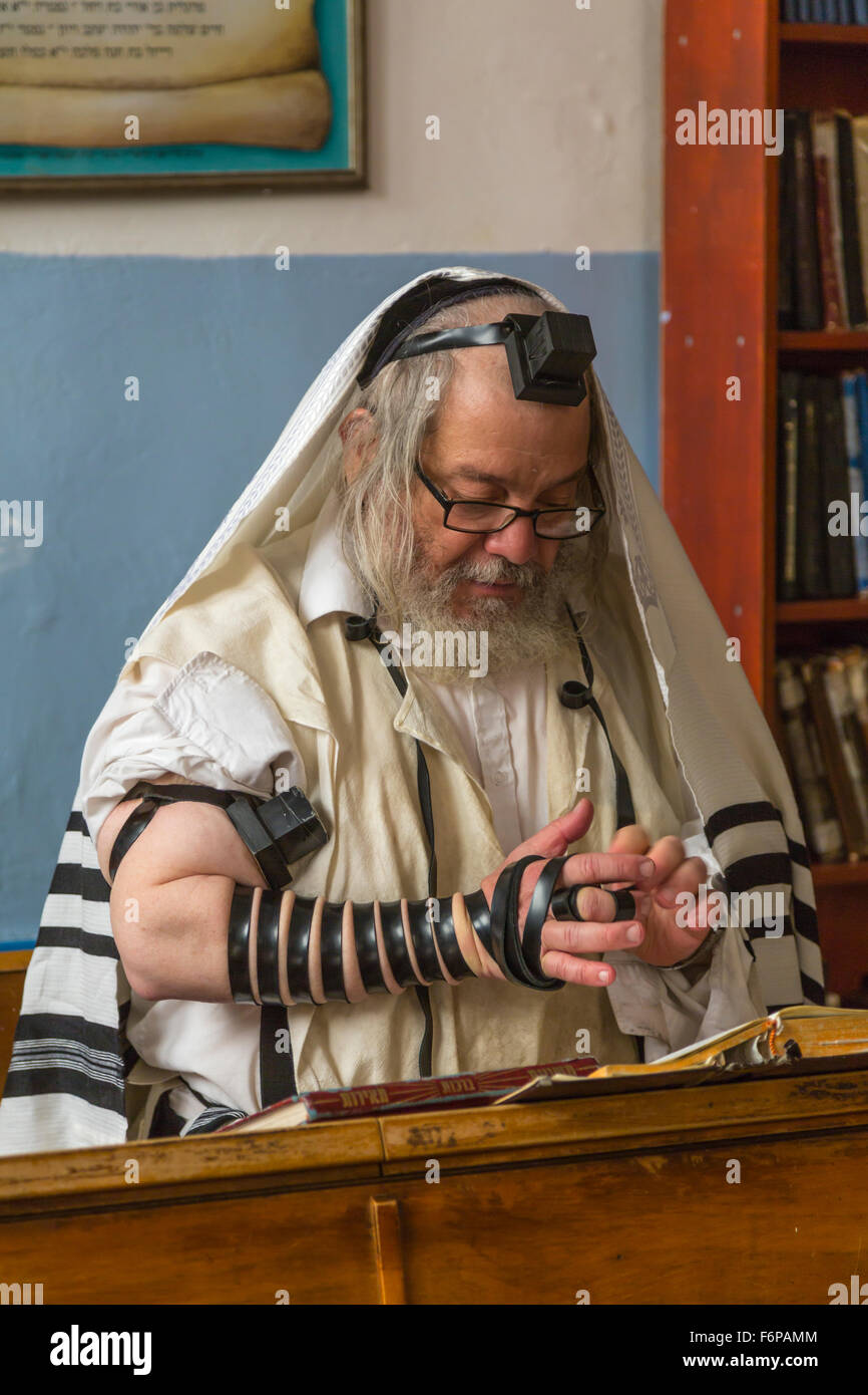 A Jewish man bind the Tefillin in a synagogue in Safed, Golan, Israel