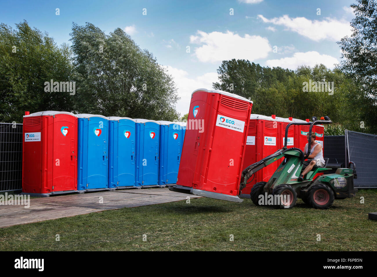 Placement of rows of colourful portable toilets at outdoor event Stock Photo