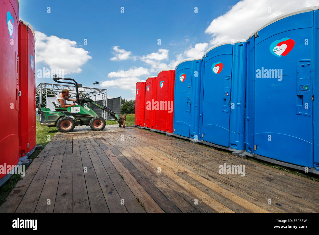 Placement of rows of colourful portable toilets at outdoor event Stock Photo