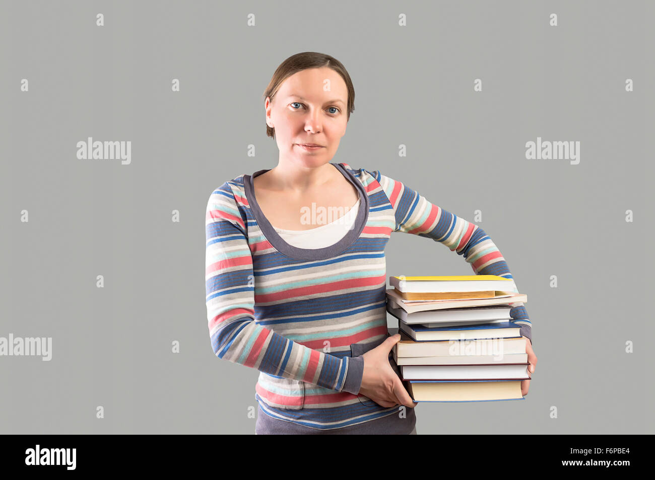 Student holding stack of books. Selective focus Stock Photo - Alamy